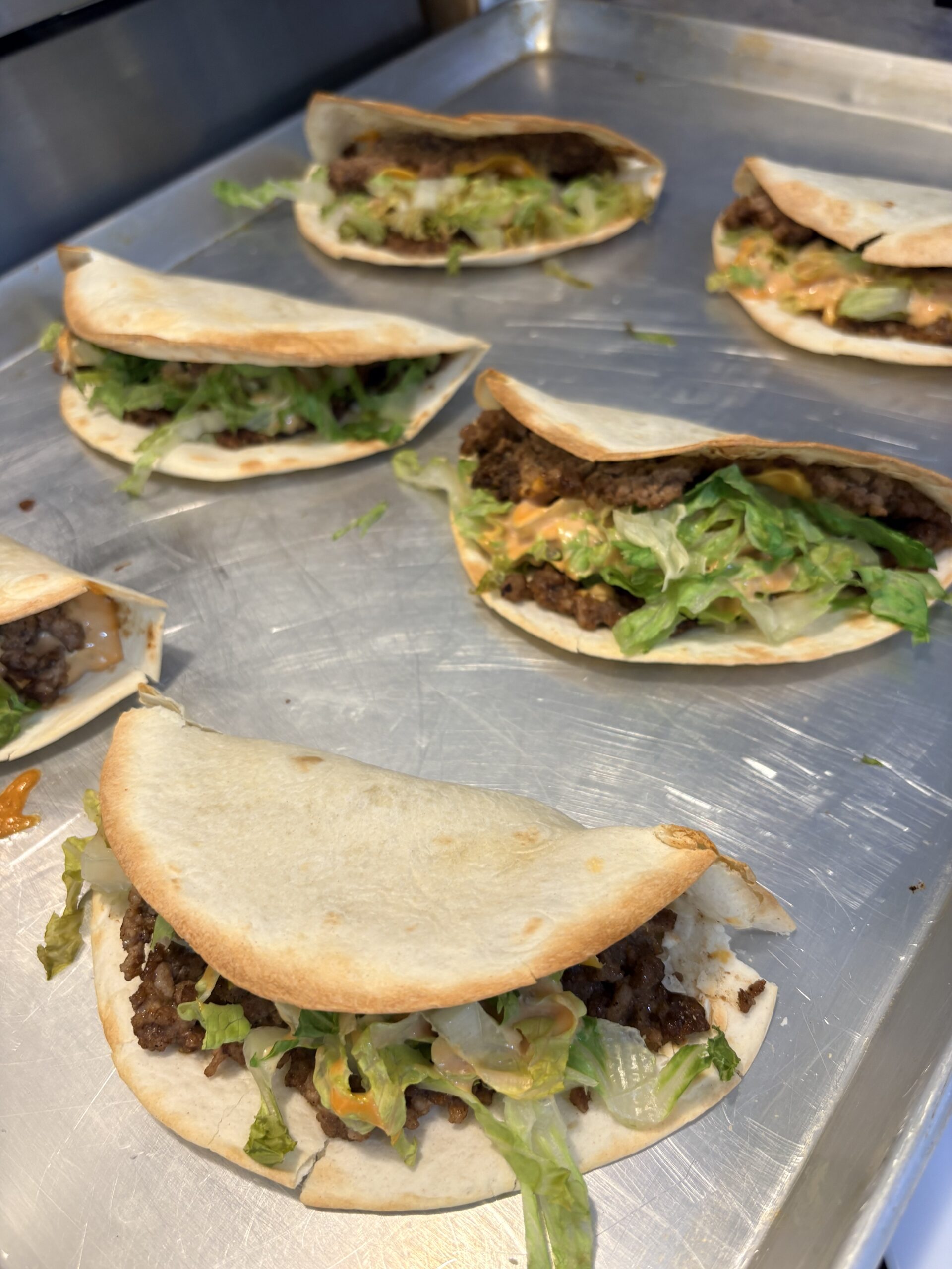 Folded cheeseburger wraps with lettuce and burger sauce